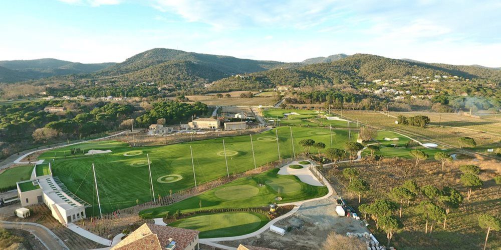 Jacksonville Aerial view of a synthetic grass golf course surrounded by hills