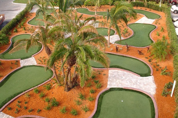 Jacksonville Aerial view of a mini golf course with synthetic grass and palm trees.