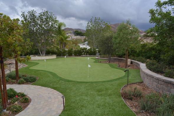 Jacksonville Synthetic grass golf green in a landscaped backyard