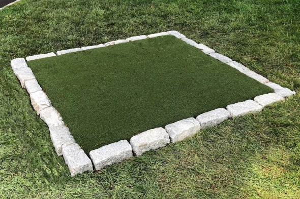 Jacksonville Tee box made of synthetic grass surrounded by stone border